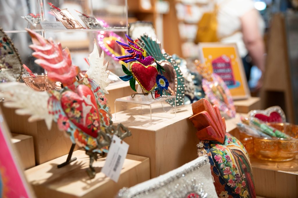 Miniatures of the same art in the hallway of the Spring Arts Collective are for sale in stores run by the artists. The FOLD Gallery, in particular, is holding a two-month-long exhibition, "Milagros & Ex Votos," from May 21 to July 22, 2025. Photographed by Julia Gu/BruinLife.