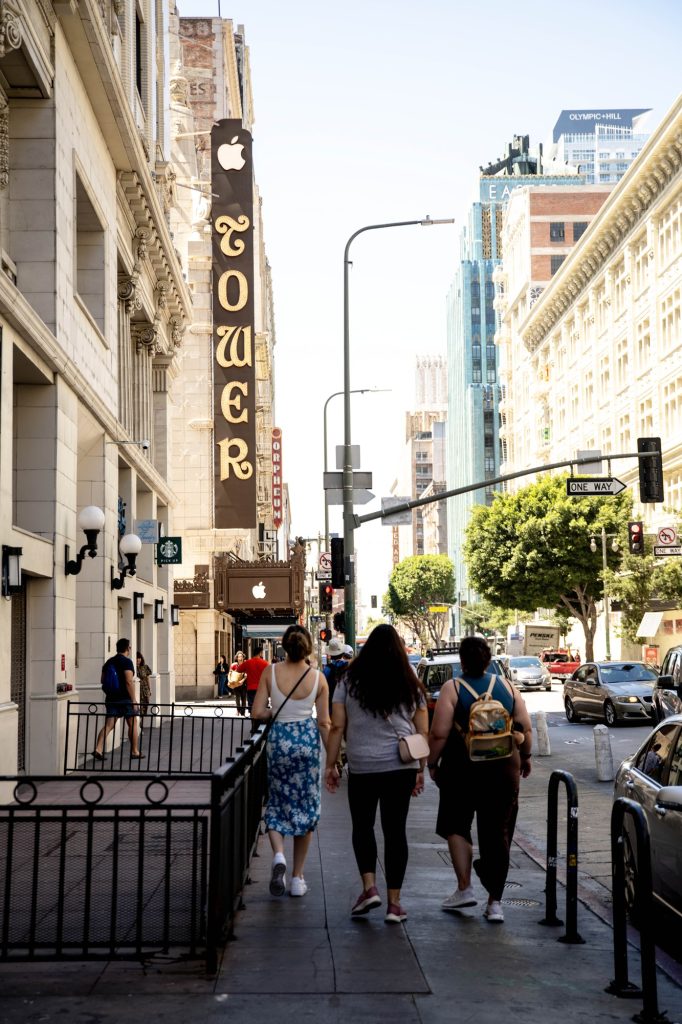 Pedestrians walk past the Theater Tower, which is now an Apple store. Photographed by Julia Gu/BruinLife.