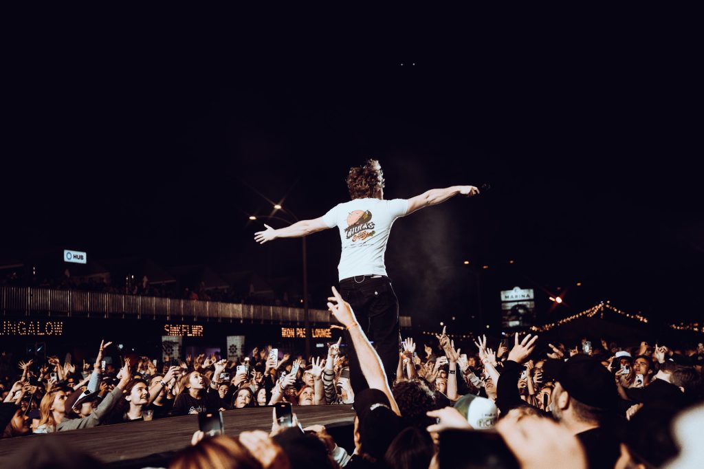 The crowd roars as Jakob Nowell of headlining act Sublime makes his way down the catwalk and sings out to the audience. Photographed by Cathryn Kuczynski/BruinLife.