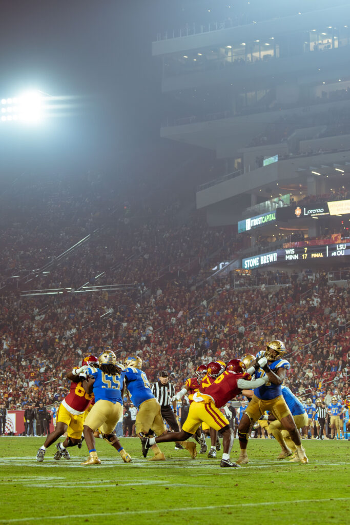 The Bruins' offensive line holds strong against the Trojans as fog engulfs the Coliseum. UCLA's front five battled hard the whole match to protect star quarterback Nico Iamaleava.