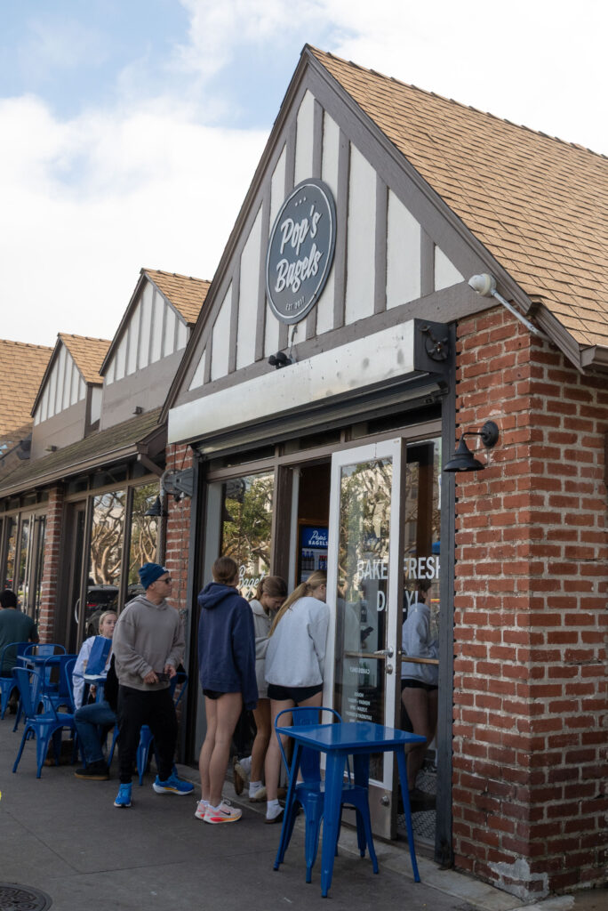 The line for Pop's Bagels stretches through the door. The restaurant offers fresh bagels as well as patio seating. Photographed by Aamani Maddukuri/Bruinlife.