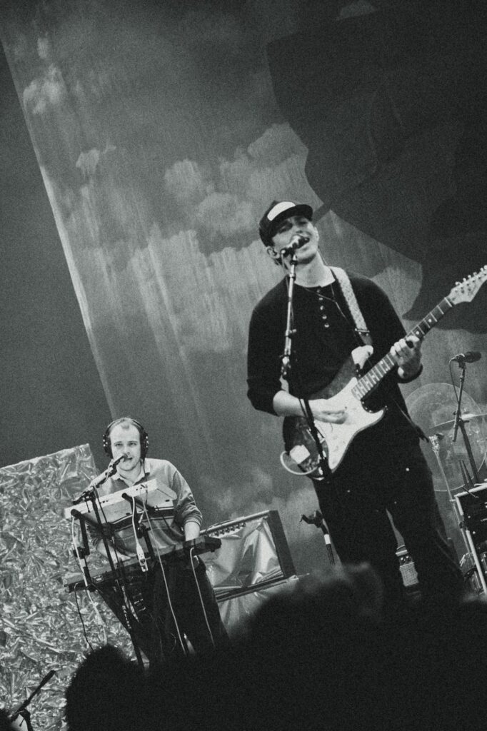 Oliver Martin sings while playing guitar as David Macey performs on keys behind him. The pair often share lead melodies, creating Krooked Kings’ mellow, melodic tone at times. Photographed by Amy Miranda/BruinLife