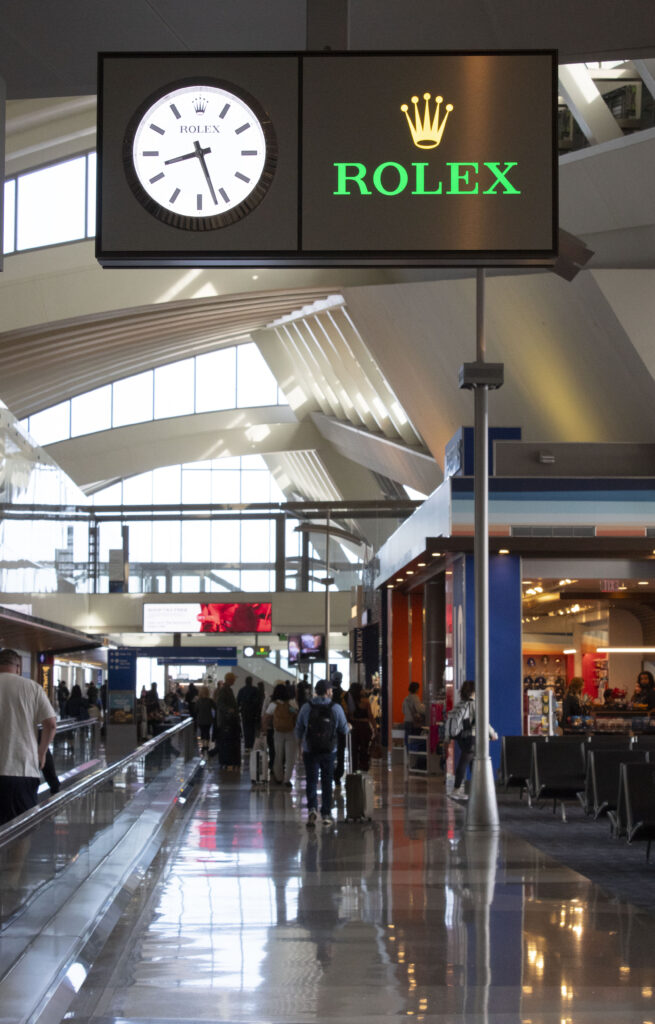 Air ports are liminal spaces filled with elusive comings and goings, where even time is "brought to you by." My boarding time crept at this petty pace from delay to delay as I watched the Rolex clock tick, tick, tick my Veterans Day weekend away. Photographed by Gavin Meichelbock/BruinLife.