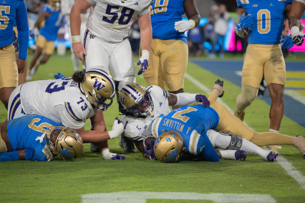 #7, Aaron Williams, protects the ball from the Husky defense. The Bruins could not stop the Huskies, giving up 48 points in their game with Washington. Photographed by Regan Rhodes/BruinLife.