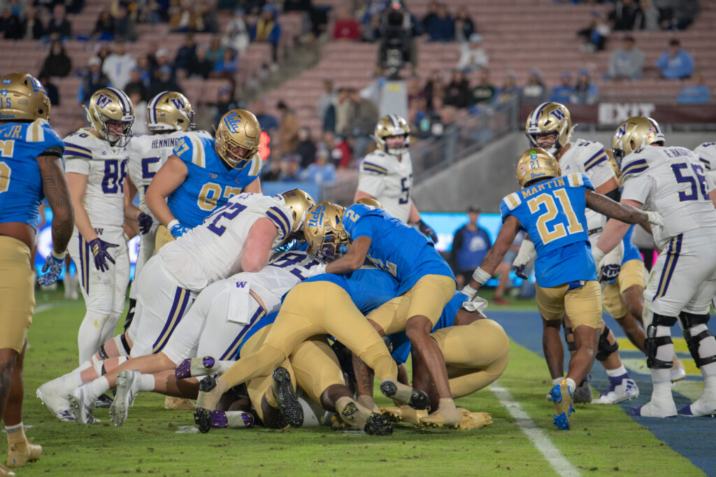The Bruins and the Huskies pile on top of the ball carrier, each trying to get possession of the ball. The Huskies were awarded the ball and after review of the play, were determined to have scored a touchdown. Photographed by Regan Rhodes/BruinLife.