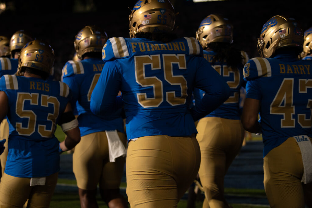 The Bruins run onto the field to begin the second half against the Huskies. The latter half of the game proved to be more productive for the Bruins, with them scoring all of their 14 points in the second half. Photographed by Regan Rhodes/BruinLife.