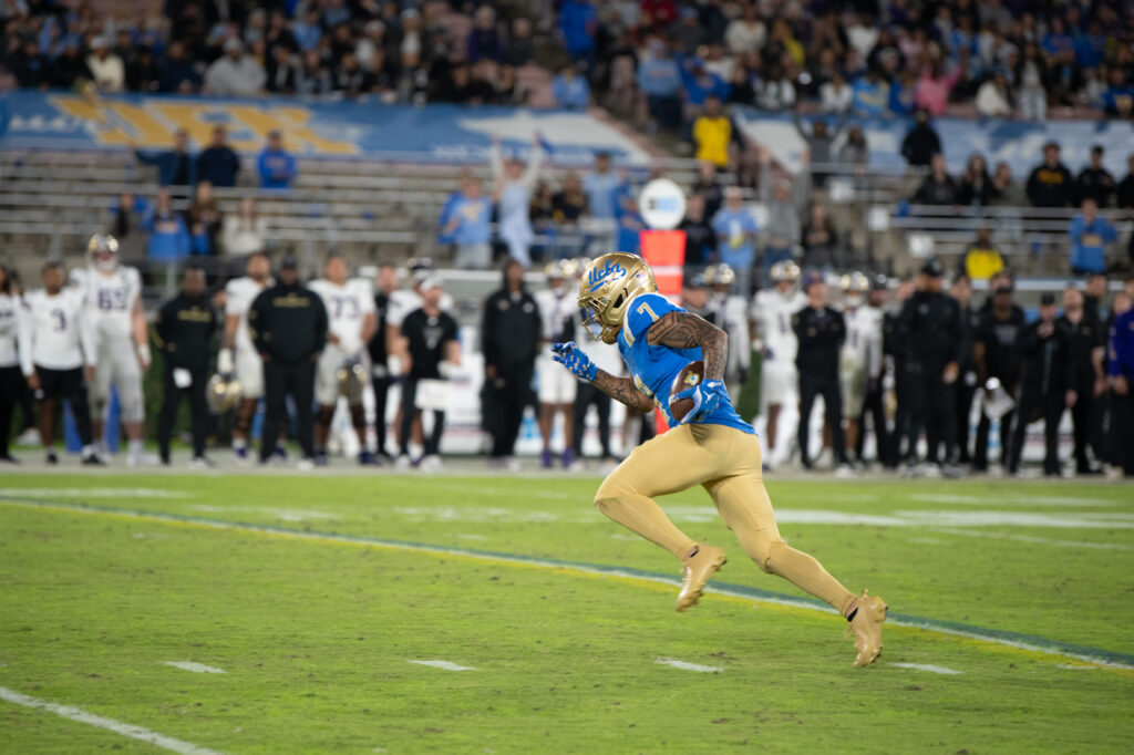 #7, Mikey Matthews, rushes towards the end zone to score a Bruin touchdown. Matthews scored the Bruins' first points against the Huskies, a 37-yard touchdown. Photographed by Regan Rhodes/BruinLife.