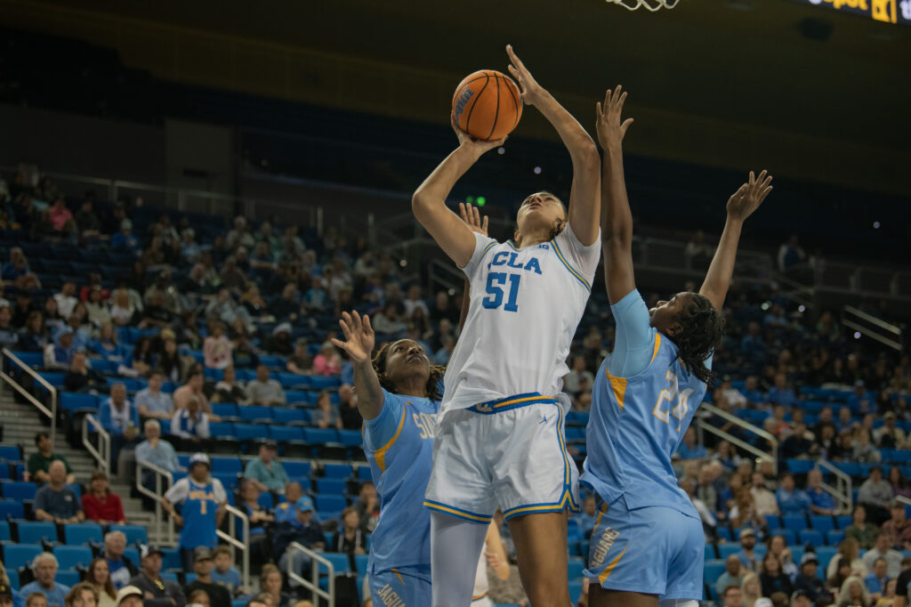 Senior center Lauren Betts shoots over the Southern University defenders. Betts added 15 points, six rebounds and three steals to the Bruin score card against the Southern University Jaguars. Photographed by Regan Rhodes/BruinLife