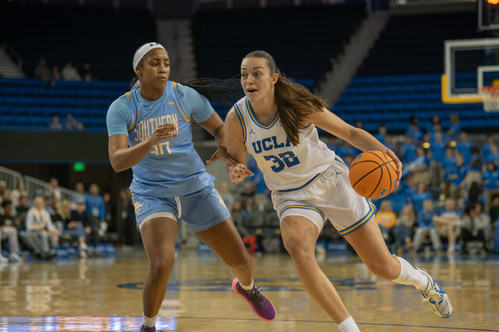 #32 Angela Dugalić dribbles towards the basket through a persistent Southern University defender. Dugalić lead the Bruins in points, scoring 20 of the team's 88 points. Photographed by Regan Rhodes/BruinLife.