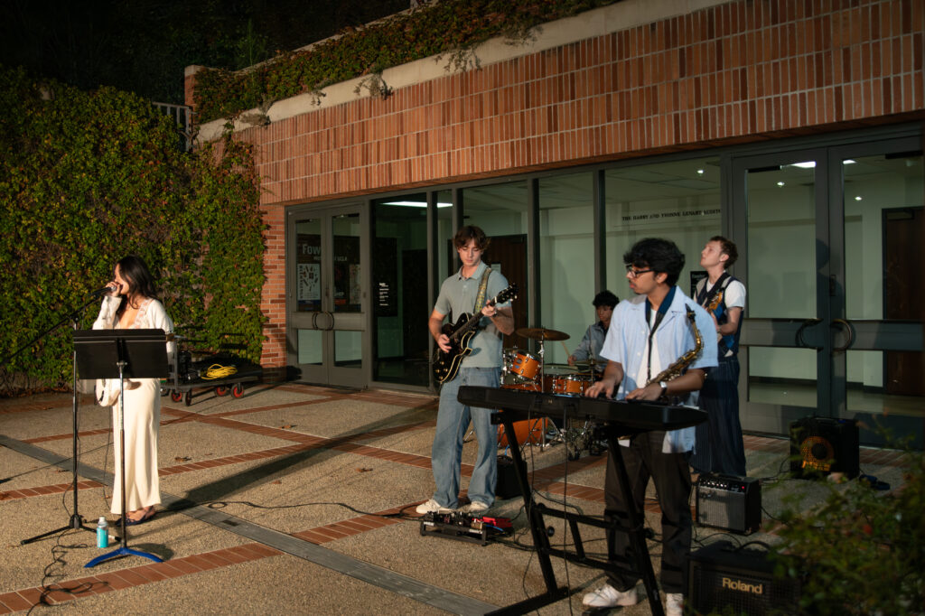 The members of 9 Ball perform infront of family and friends at the Fowler Amphitheater. Their set consisted of a wide range of songs from originals to covers. Photographed by Siena Hunt/BruinLife
