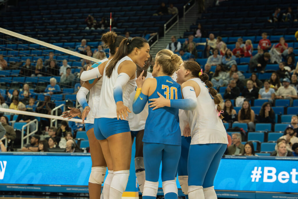 No. 30, Lola Schumacher, receives feedback from her teammate during a huddle. Photographed by Sapna Drew/BruinLife.