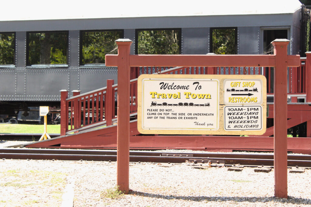 The sign says it all: Welcome to Travel Town — restrooms to the right. Photo by Gavin Meichelbock/BruinLife.