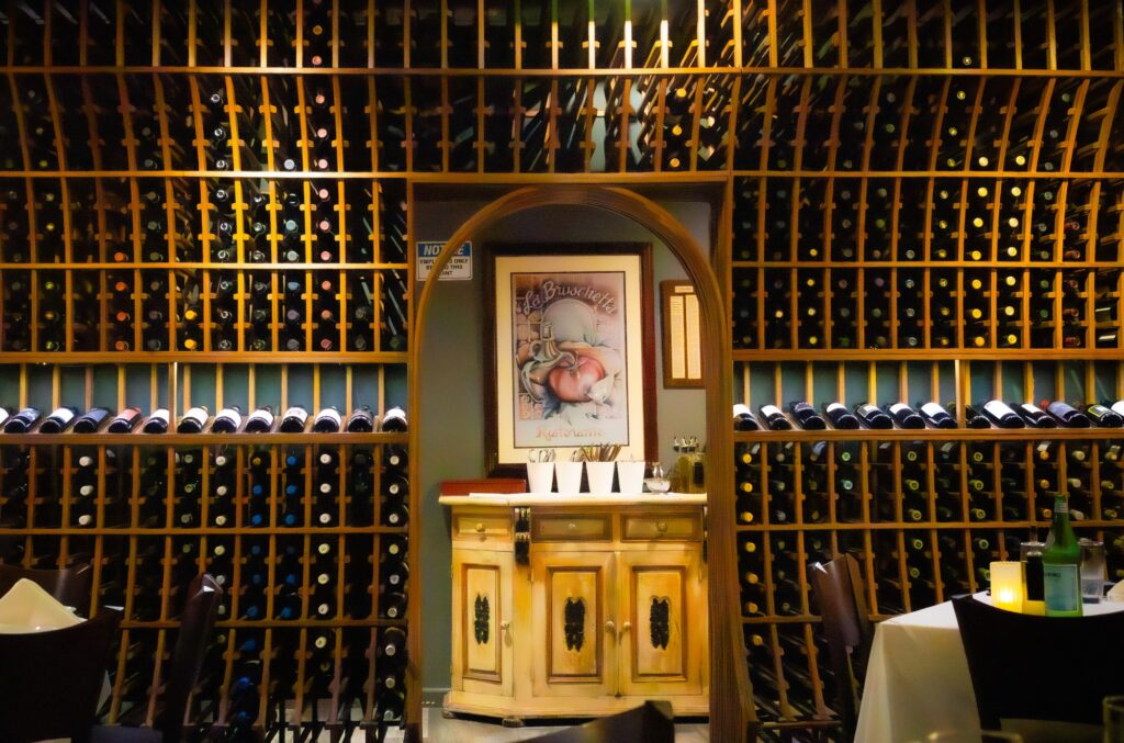 A view of the back wall lined with wine bottles, capturing the warm ambiance of the restaurant. The overall atmosphere and attentive service were notably welcoming. Photographed by Siena Hunt/BruinLife