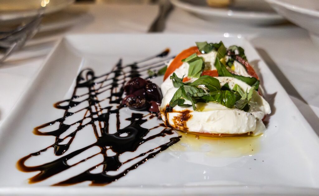 Insalate Caprese made with fresh tomato slices, buffalo mozzarella, and basil. The traditional and simple combination came together as a light, flavorful starter. Photographed by Siena Hunt/BruinLife
