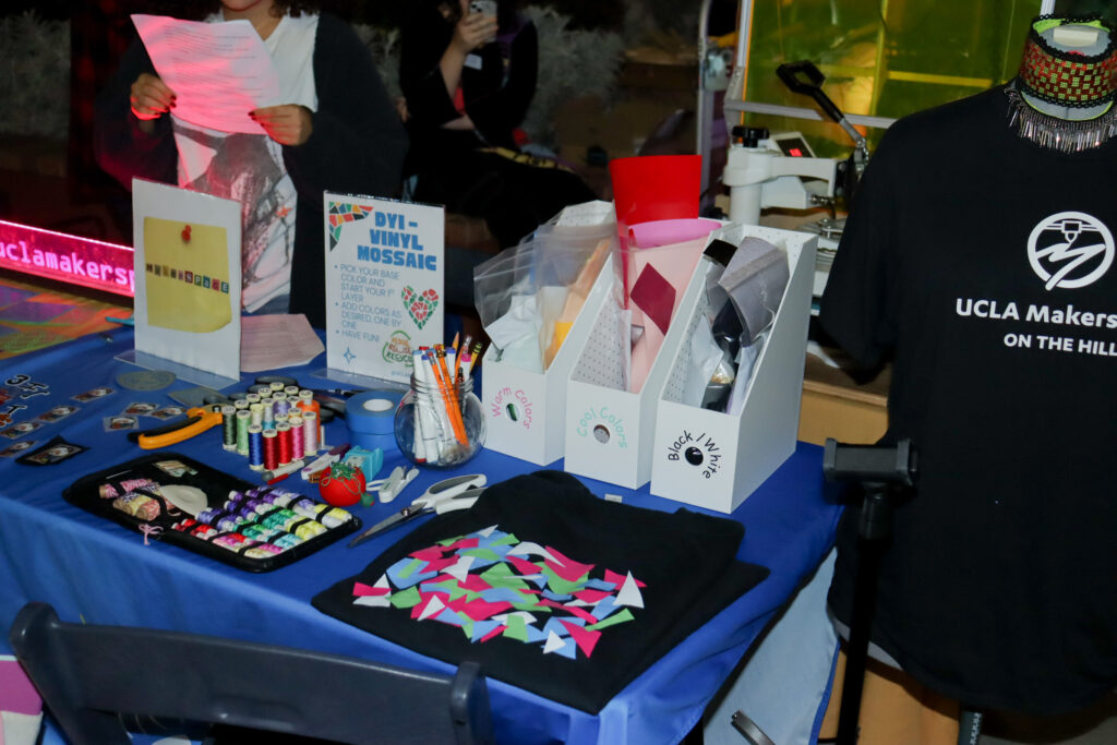 Many different crafts and activities sit on the UCLA Makerspace table at Sustainival. The Makerspace provides students access to all kinds of equipment, like sewing machines and 3D printers. Photographed by Regan Rhodes/BruinLife.