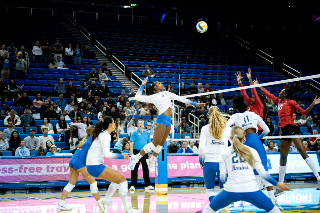 Cheridyn Leverette locks onto the ball as she attempts a spike. Leverette's powerful hits help propel the Bruins to victory. Photographed by Janwayne Orme/BruinLife.