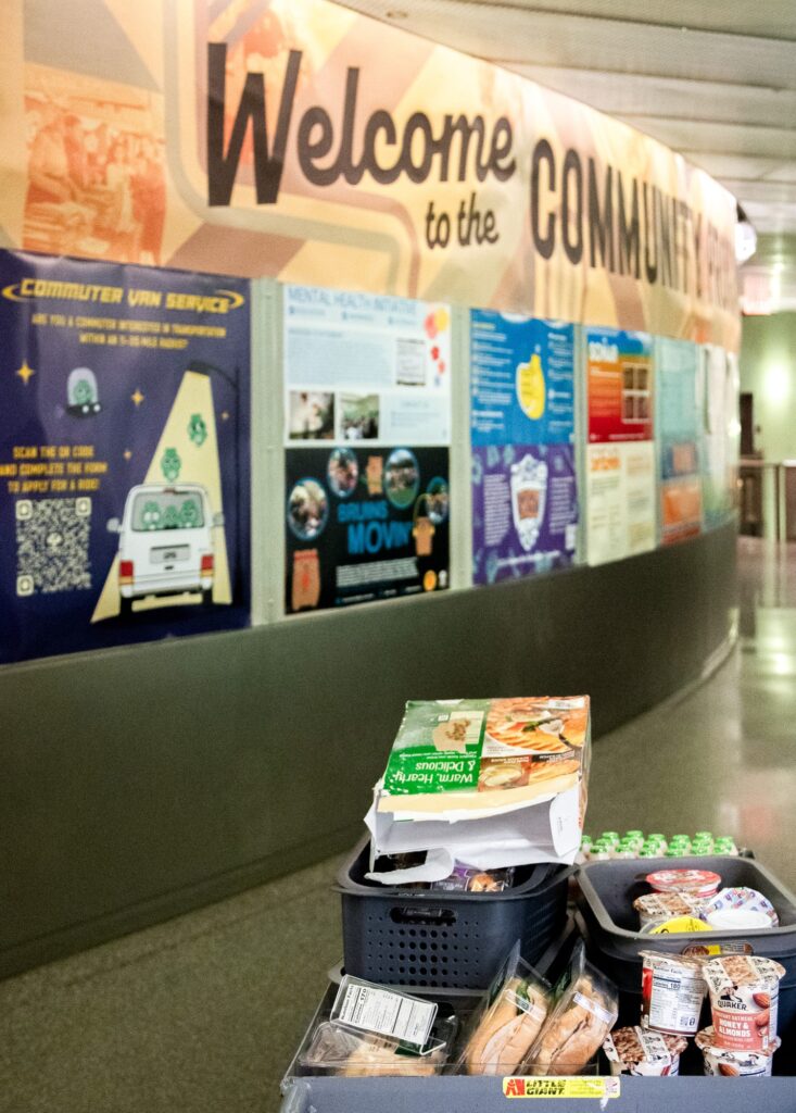 The food cart that CPO employees use to restock the Food Closet stands in the UCLA Student Activity Center hallway, filled to the brim with breakfast options for the day. Photographed by Aaron Fu/BruinLife.