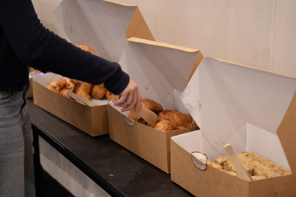 Students picks up pastries in the Coffee Chat with Student Ambassadors. Photographed by Aaron Fu/BruinLife