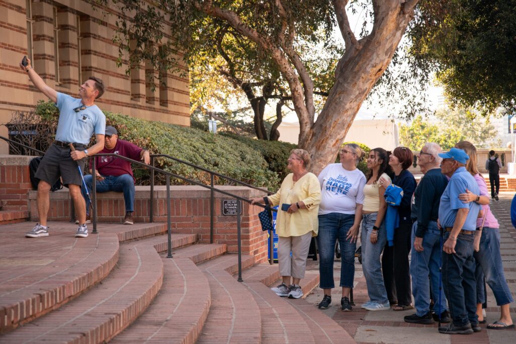A large family poses for a group photo on the steps of Powell library, just near the Bruin Family Weekend dining area in the Dickson plaza. Photographed by David Zakaryan/BruinLife.