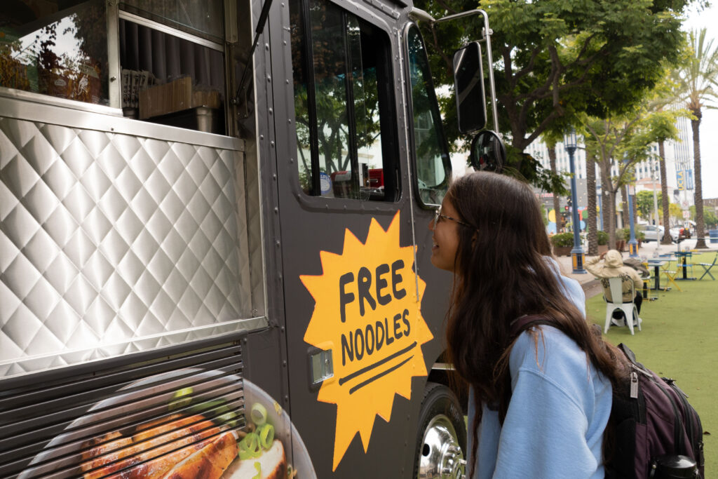 Maria Kesisoglou orders from the Momofuku pop-up. The food truck offers free noodles as part of their promotional tour around Los Angeles. Photographed by Aamani Maddukuri/BruinLife.