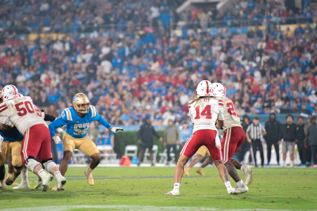 Nebraska's quarterback TJ Lateef hands the football off to his runningback Emmett Johnson. Johnson finished the night with three touchdowns. Photographed by Luana Caravalho/BruinLife.