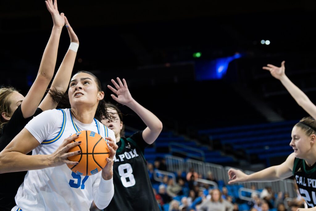 Center Lauren Betts gears up to shoot as four Cal Poly players including guard Katie Peiffer attempt to block her. The defense was futile, as Betts easily scored another two points for the unstoppable Bruins. Photographed by Asher Nee/BruinLife.