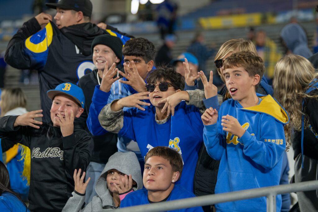 A group of boys in UCLA gear put their 4's up to show support to the Bruin football team. These fans all repped the UCLA blue and gold while cheering on the Bruins against Washington. Photographed by Regan Rhodes/BruinLife.
