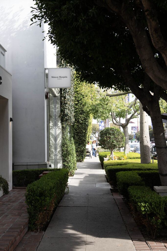 People on the side walk outside Maison Margiela on Melrose Place. Photographed by Aaron Fu/BruinLife.