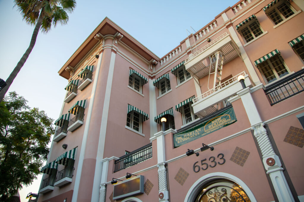 The exterior of the Black Rabbit Rose Magic building with palm trees adjacent to it. The balconies and balustrade stood out of the building that added a sense of mysteriousness. Photographed by Aaron Fu/Bruinlife