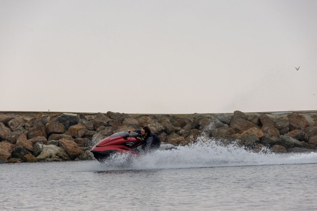 A man on a jet ski cuts through the calm water in Marina del Rey.