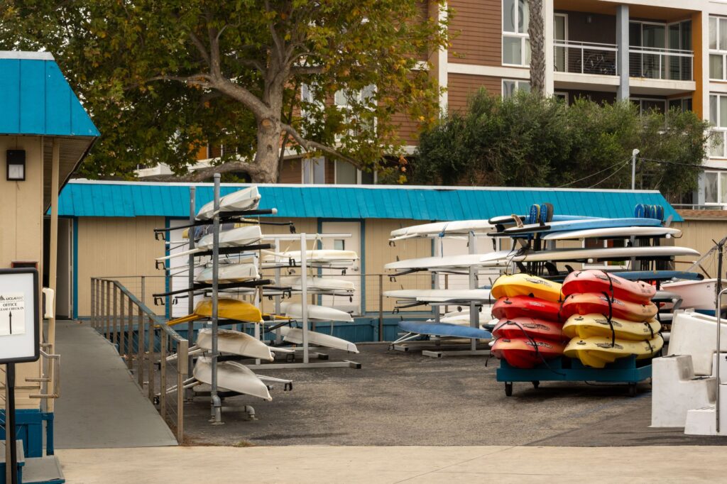 Rows of colorful kayaks lie neatly stacked on top of each other, ready for the taking. Photographed by Jaclyn Wang/BruinLife.