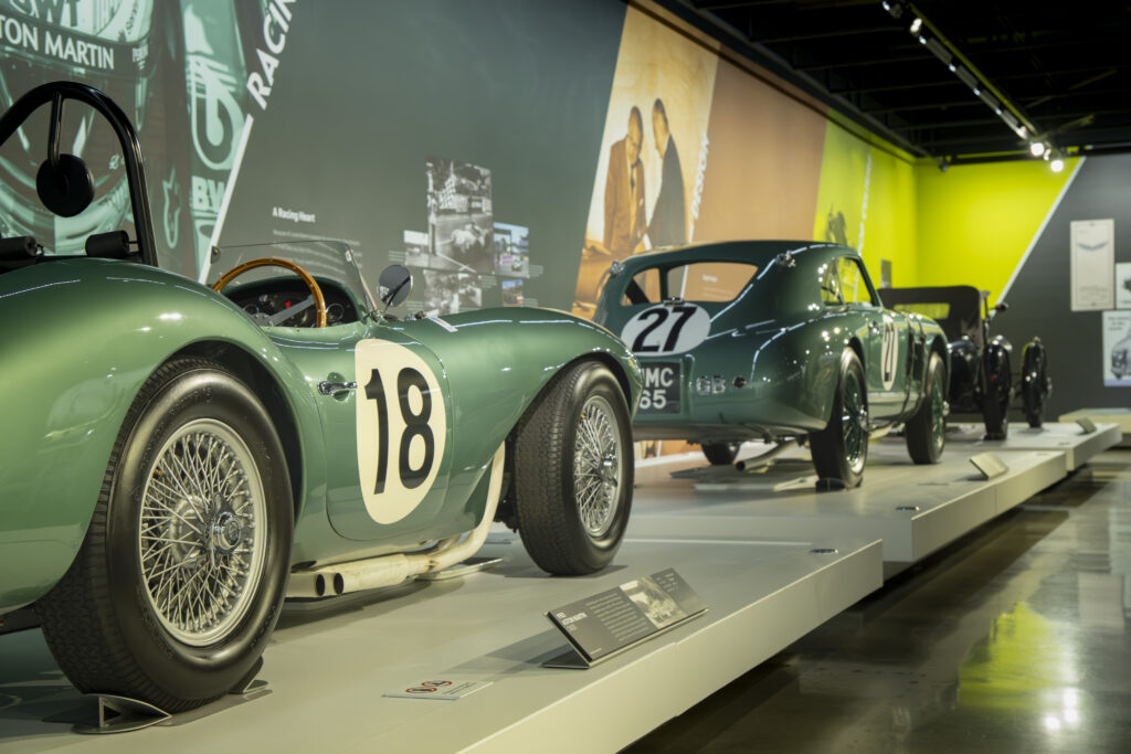 Classic Aston Martin race cars on display. Their iconic green finishes highlight the brand’s rich racing heritage. Photographed by Janwayne Orme/BruinLife.