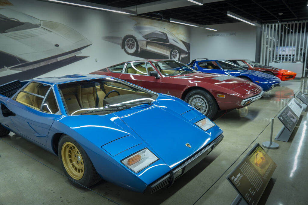 A lineup of classic Italian sports cars on display. The front car is a Lamborghini Countach, showcased alongside other iconic models. Photographed by Janwayne Orme/BruinLife.