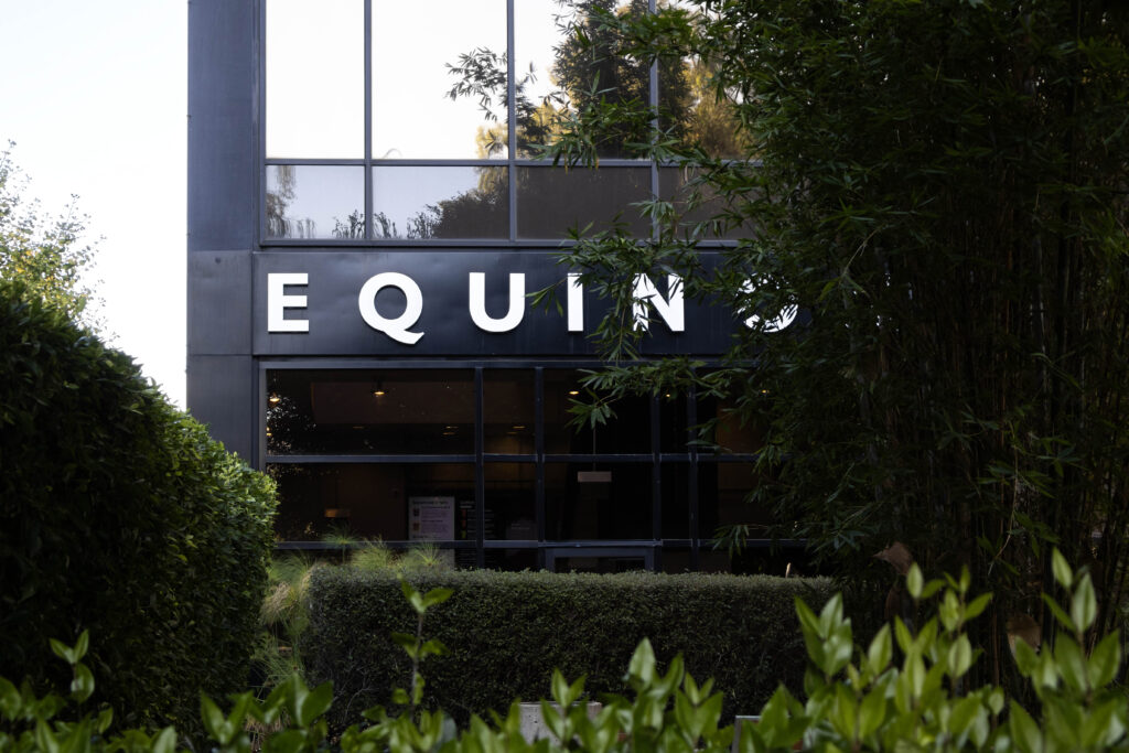 Bamboo leaves partially cover the sign at Equinox Westwood. With just an initial scan, the machine at its spa can construct a 3D model of the client's body to tailor the massage to each individual. Photographed by Julia Gu/BruinLife.