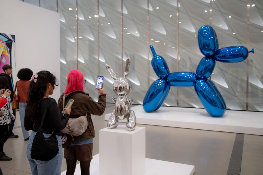 Tourists interacting with the artworks "Blue Balloon Dog" and "Rabbit" by Jeff Koons, two of the signiture art pieces of The Broad Museum. Photographed by Aaron Fu/BruinLife.