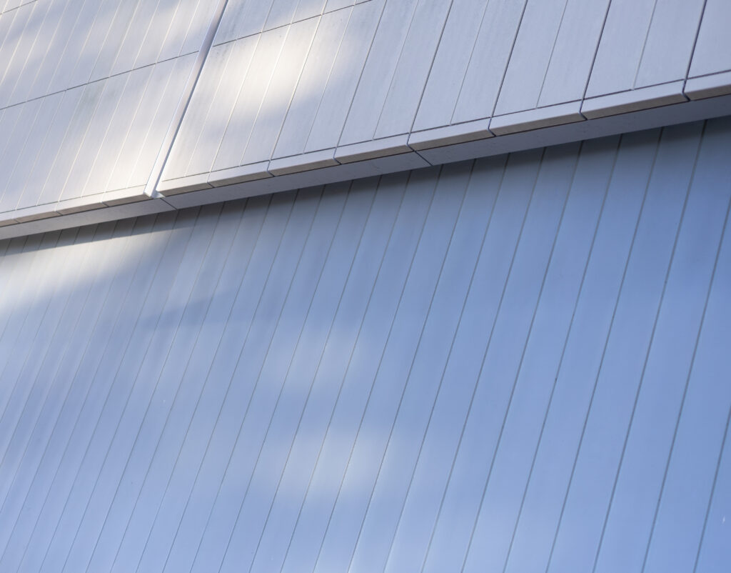 Trees cast shadows on Pauley Pavillion, producing a pastel blue pastel hue. Photographed by Sapna Drew/BruinLife.